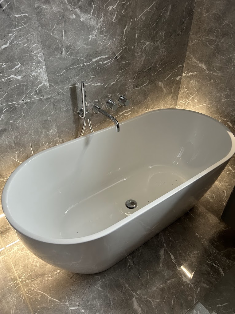 Bathroom with backlit freestanding bath