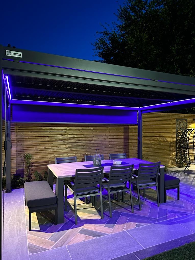Pergola with purple LED ambient lighting over dining area