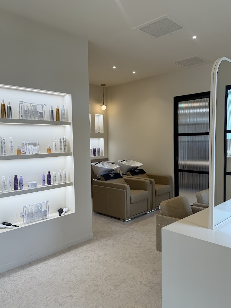 Salon wash area with backlit retail display shelving