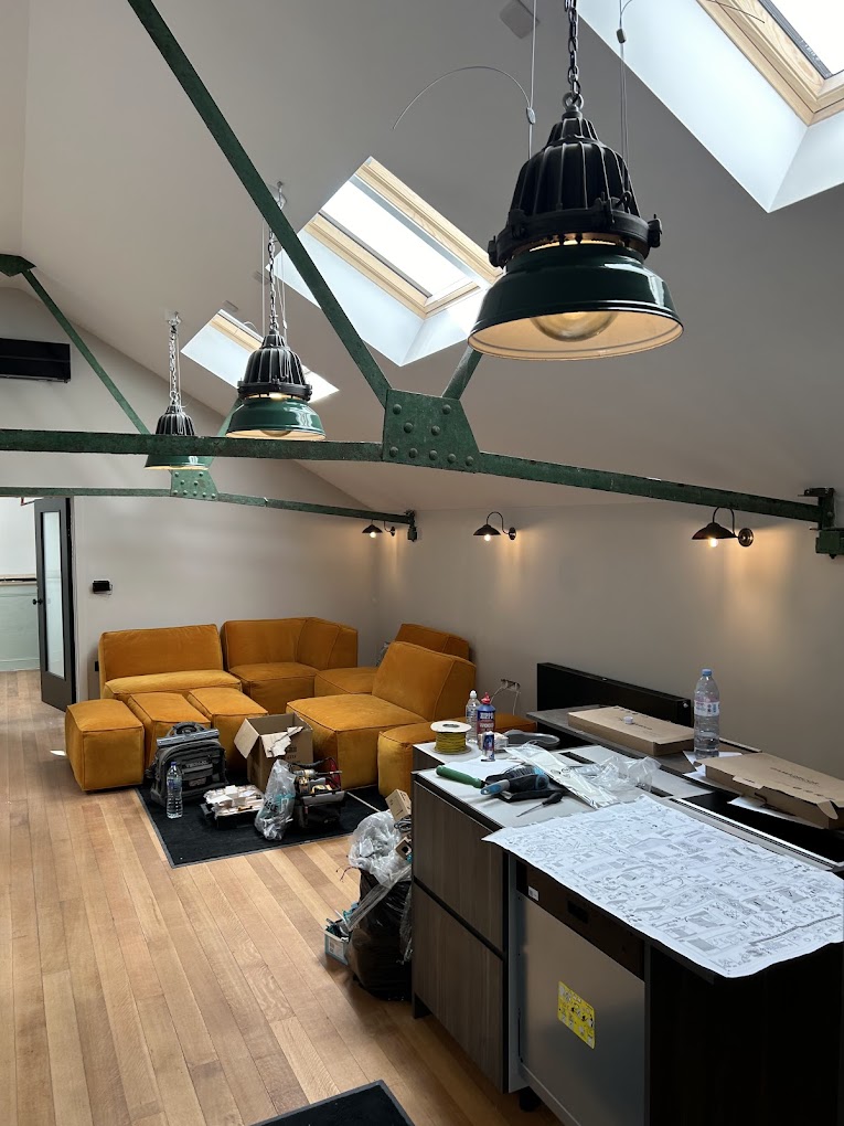 Loft conversion with industrial pendant lights and wall sconces