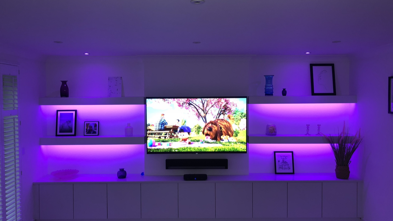 LED shelf lighting around media wall